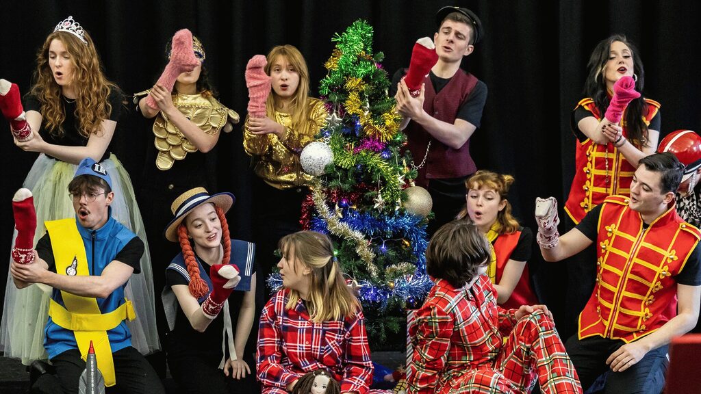 Scottish Opera Young Company singing, dressing in festive clothes holding toys. Credit Sally Jubb