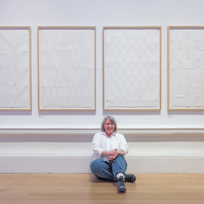Charlene Scott sat in front of her artwork after being awarded the Tonic Arts Purchase Prize