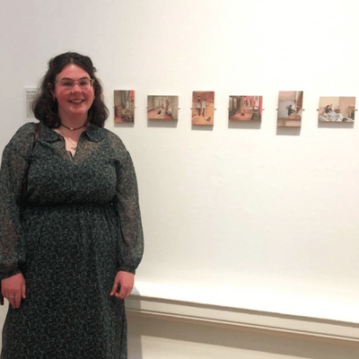 Tegan Chaffer stood with her artworks after being awarded the Tonic Art Purchase Prize