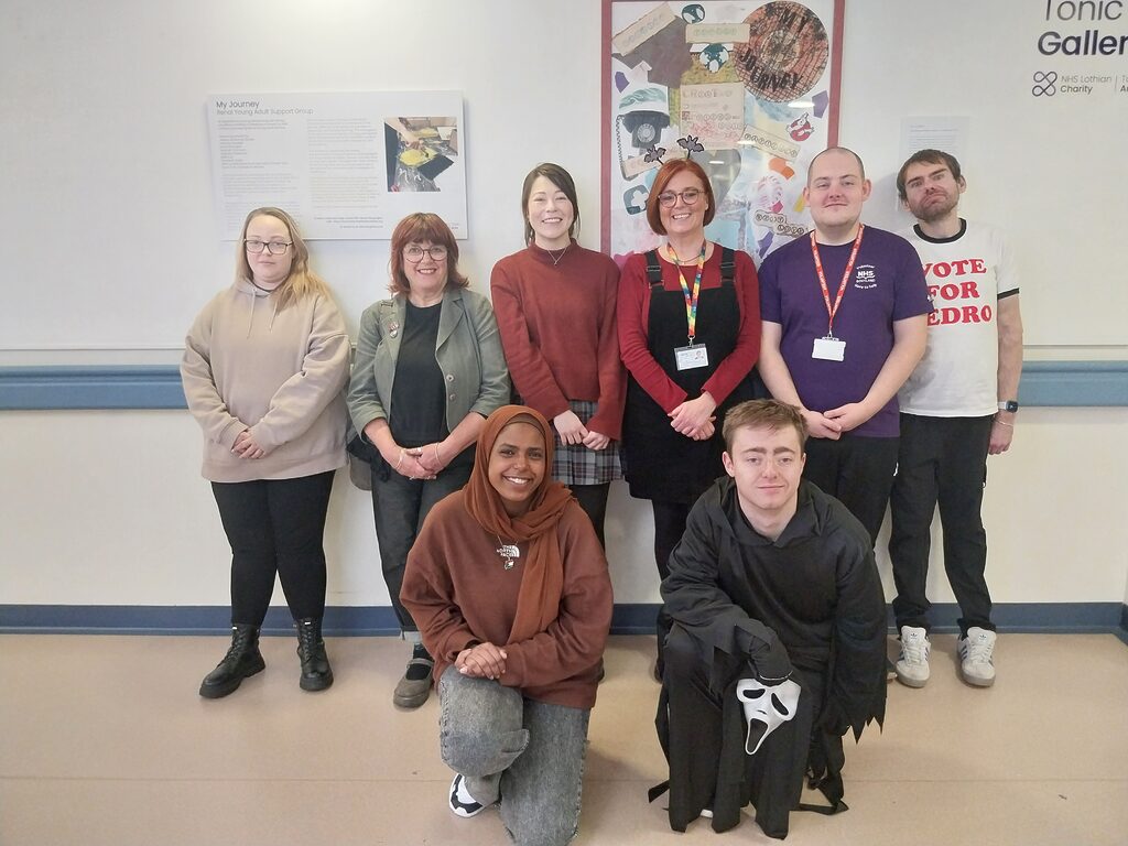 Group of young adults in front of artwork