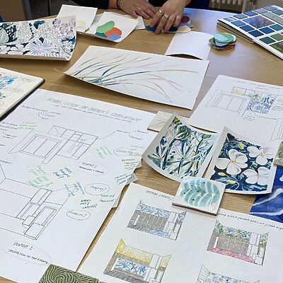 Artist, Natasha Russell, sharing sketches of the designs for the Chalmers Centre with staff