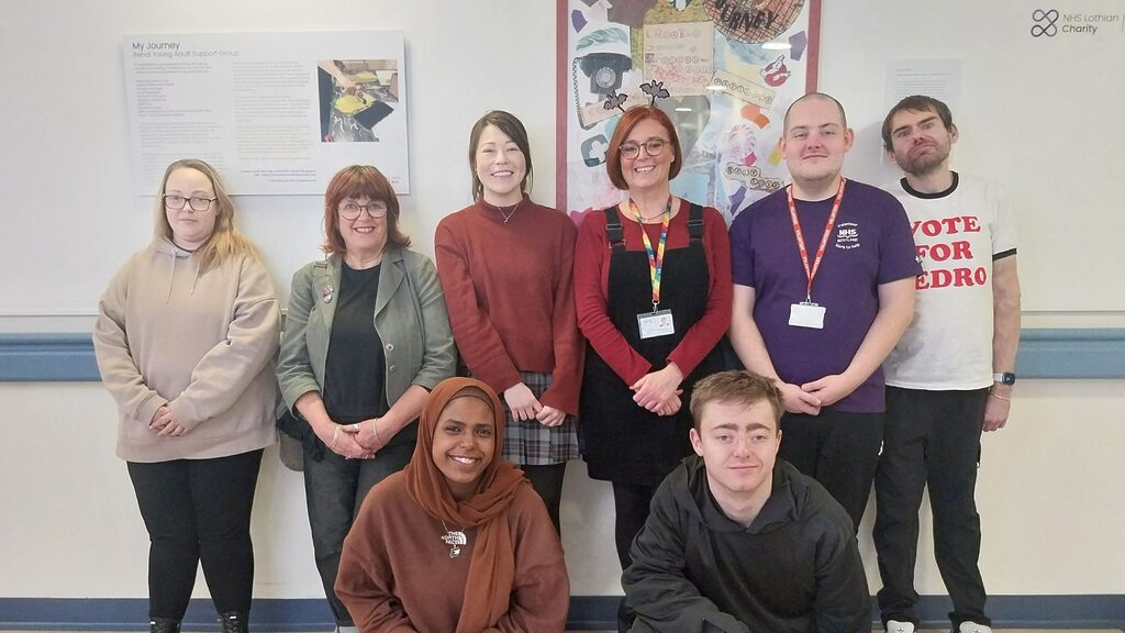 patients and staff standing in front of artwork
