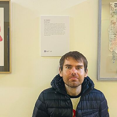 a patient standing in front of their artwork