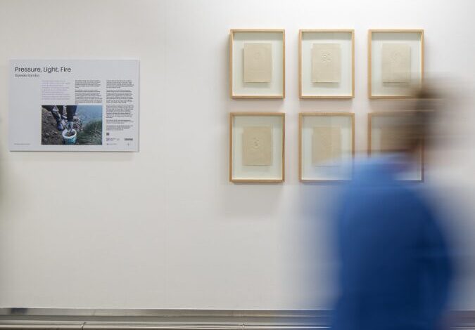 Person walking past Daniele Sambo's work