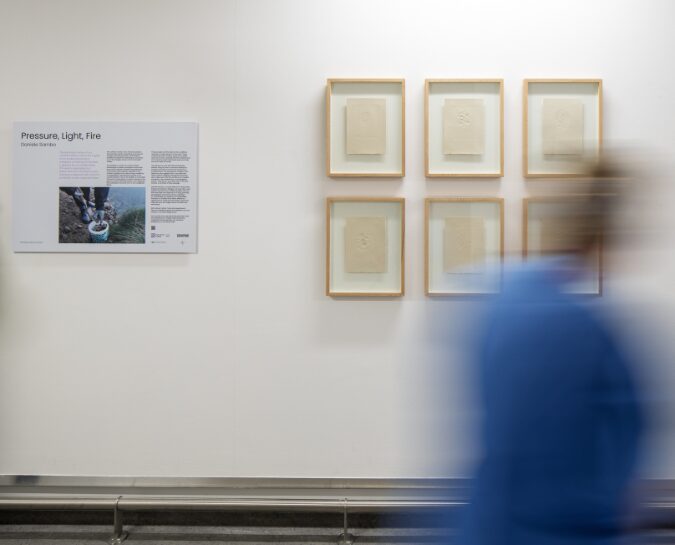 Person walking past Daniele Sambo's work