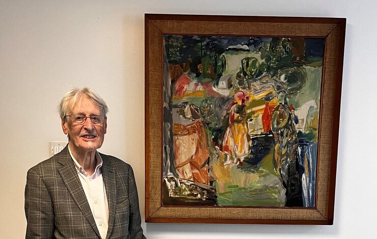 Dr Duncan Thomson standing beside his artwork: Across the Land