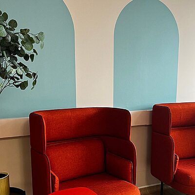 chairs framed by painted arch design in the staff wellbeing space at St John's Hospital
