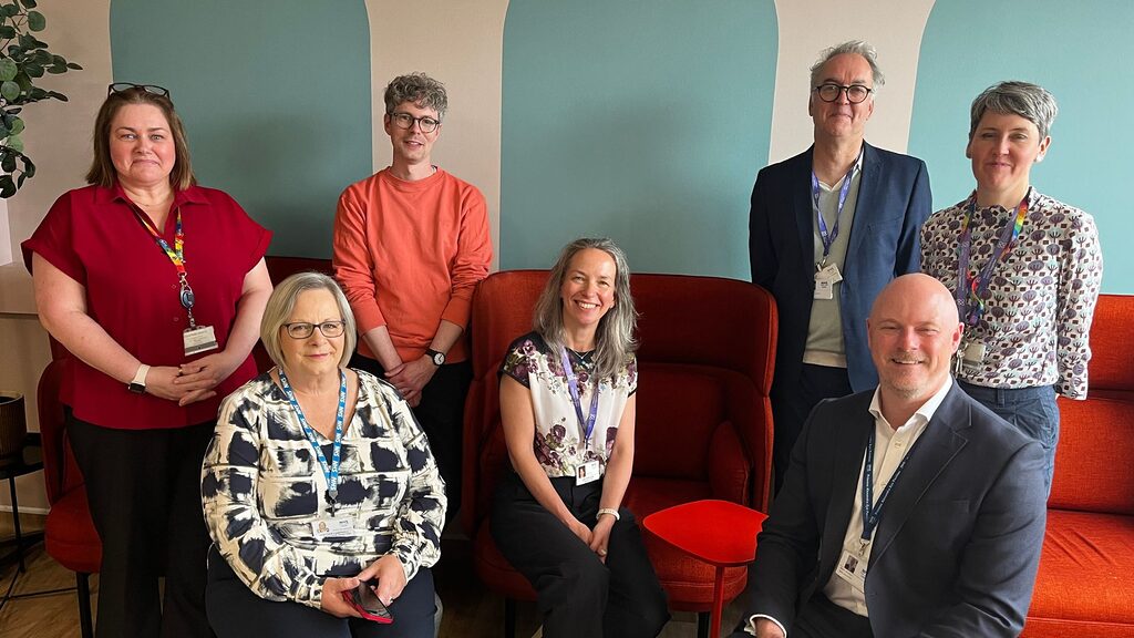 group of people smiling at the camera in the staff wellbeing space at St John's Hospital