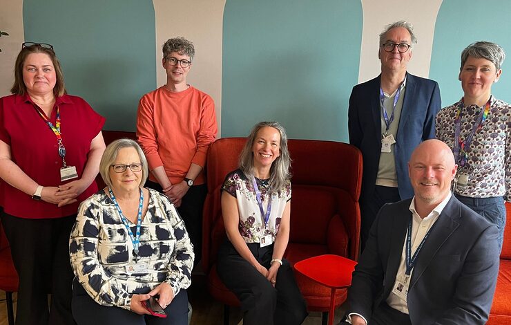 group of people smiling at the camera in the staff wellbeing space at St John's Hospital