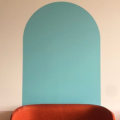 Close up of chair and painted arch design in the staff wellbeing space at St John's Hospital