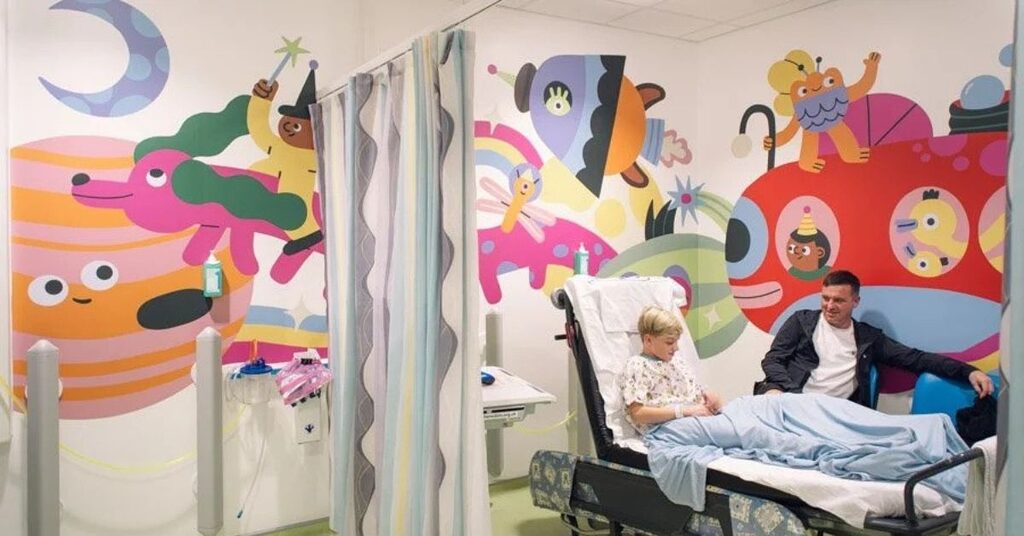 Crichton Ward with boy and dad in hospital bed
